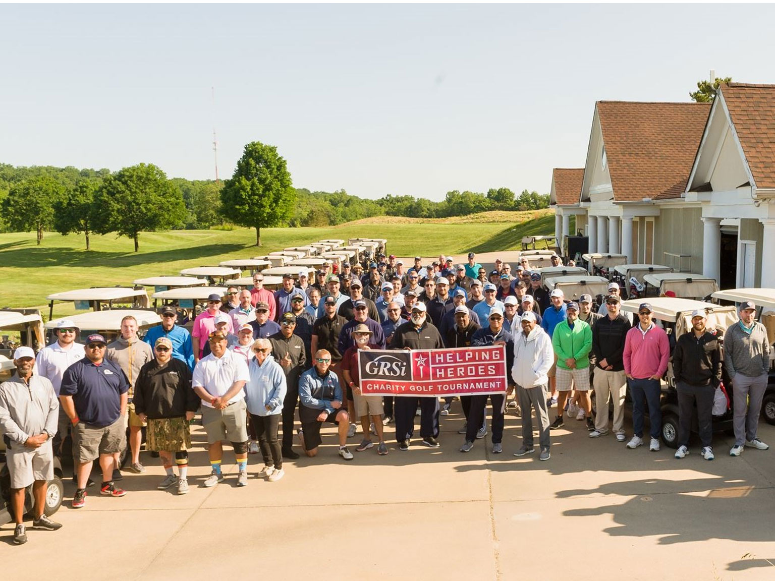 Helping Heroes: Charity Golf Tournament participants take a group photo.